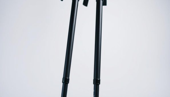 A close-up of a pair of sleek, lightweight carbon fiber trekking poles standing upright against a plain, minimalist background. The poles have a matte finish, showcasing their durable and high-quality construction. Vibrant highlights on the poles create a sense of depth and premium craftsmanship. The poles are angled slightly to create a dynamic and visually appealing composition. Soft, diffused lighting illuminates the scene, emphasizing the technical details and the overall premium nature of the hiking gear. A close-up of a pair of sleek, lightweight carbon fiber trekking poles standing upright against a plain, minimalist background. The poles have a matte finish, showcasing their durable and high-quality construction. Vibrant highlights on the poles create a sense of depth and premium craftsmanship. The poles are angled slightly to create a dynamic and visually appealing composition. Soft, diffused lighting illuminates the scene, emphasizing the technical details and the overall premium nature of the hiking gear.