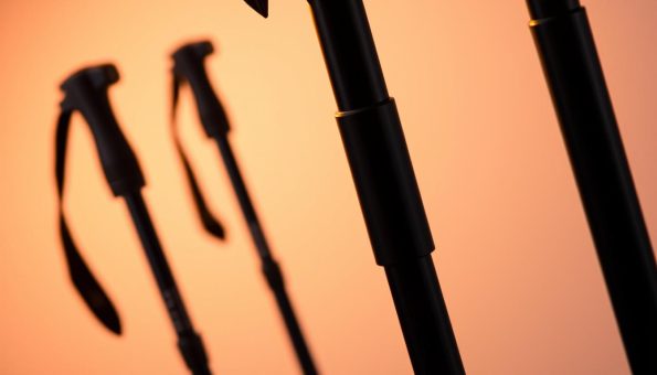 Sleek carbon fiber trekking poles, their matte black shafts gleaming under warm studio lighting. Sturdy ergonomic grips and durable tungsten carbide tips visible in the foreground, conveying the poles' rugged functionality. In the middle ground, the poles are angled dynamically, suggesting their lightweight responsiveness and ability to effortlessly traverse uneven terrain. The background fades to a soft, desaturated gradient, keeping the focus on the precision-engineered carbon fiber design. The overall mood is one of high-performance outdoor equipment, ready to empower adventurous treks through challenging environments. Sleek carbon fiber trekking poles, their matte black shafts gleaming under warm studio lighting. Sturdy ergonomic grips and durable tungsten carbide tips visible in the foreground, conveying the poles' rugged functionality. In the middle ground, the poles are angled dynamically, suggesting their lightweight responsiveness and ability to effortlessly traverse uneven terrain. The background fades to a soft, desaturated gradient, keeping the focus on the precision-engineered carbon fiber design. The overall mood is one of high-performance outdoor equipment, ready to empower adventurous treks through challenging environments.