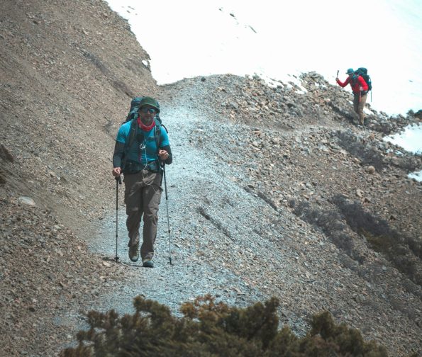 Hikers using different types of trekking poles in various terrain conditions Hikers using different types of trekking poles in various terrain conditions